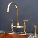 Unlacquered brass curved legs bridge faucet – side view showing curved leg design