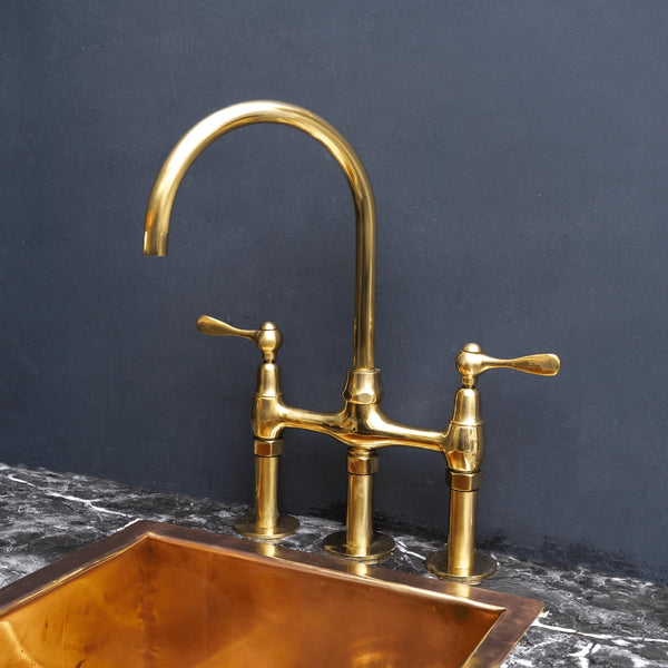 Unlacquered brass 3-hole bridge kitchen faucet – two-handle design, front view