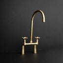 Prestige unlacquered brass bridge kitchen faucet – refined silhouette, front view