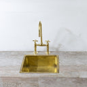 Unlacquered brass bridge faucet modern – installed in contemporary kitchen