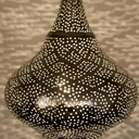 Brass pierced pendant light hanging in living room with warm amber glow – Brass For Homes
