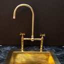 Polished brass bridge kitchen faucet high arc – front view showing gleaming finish