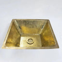 Unlacquered brass bathroom sink – close-up showing hand-hammered texture