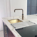 Unlacquered brass kitchen sink close-up of hand-hammered artisan finish – Brass For Homes