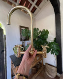 Unlacquered brass bridge kitchen faucet with lever handles – front view