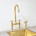 Brass bridge kitchen faucet with pull-down sprayer – lifestyle kitchen view