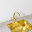 Unlacquered brass gooseneck kitchen faucet – installed over deep kitchen sink
