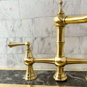 Unlacquered brass 3-leg column faucet – close-up of leg and spout detail