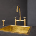 Unlacquered brass bridge faucet with cross handles – three-hole installation view